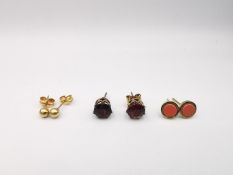 Three pairs of 9ct and yellow metal stud earrings, including a pair set with round mixed cut garnets