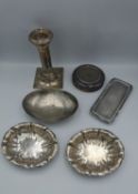 A collection of silver, including a weighted silver candle stick, an oval dish with engraved