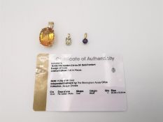 Three 20th century 9 carat gold gem-set pendants, one with a certificate. A Citrine pendant set with