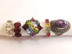 A collection of five silver and gold plated silver dress rings set with various gemstones, including