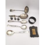 A collection of silver to include silver three thimbles, a ladle, four spoons, a picture frame