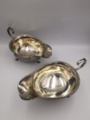 Two sterling silver Harrods gravy boats with foliate form feet and C-scroll handle. Hallmarked: