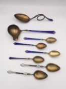 A collection of Norwegian gilded silver and royal blue guilloche enamel and white enamel spoons,