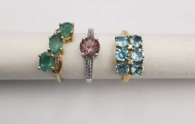Three 20th century 9 carat gold gem-set rings with certificates. An emerald and diamond three