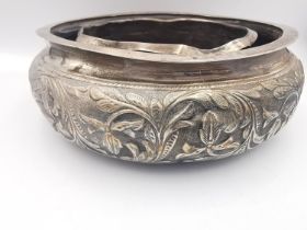 An Indian white metal repousse foliate design flower bowl with inner wall. Mark to base. Weight 153g