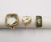 Three 20th century 9 carat gold gem-set rings, a pale yellow stone and diamond flanked solitaire