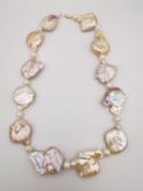 A Keshi baroque pearl and fresh water pearl knotted statement necklace with 18ct yellow gold