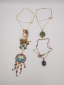 Four 20th century gold plated silver pendants and chains, a peridot and garnet cluster marquise