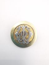 A yellow metal (tests as 18ct) and white metal (tests as platinum) circular medal brooch. The brooch
