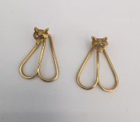 A pair of yellow metal (tests as 18ct) diamond set carved fox head bookmarks/clips. Each of the