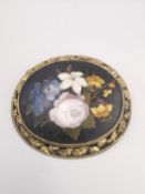 A 19th century grand tour Italian Pietra Dura brooch. The oval panel with a pale pink rose, white