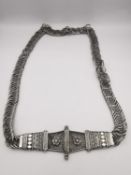 A 19th century Indian silver chain link belt with wirework buckle decorated with flowers. The belt