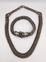 A traditional Indian silver spiral chain link rope necklace and matching bracelet. The bracelet