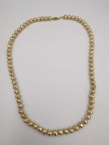 A faceted 9ct yellow gold bead necklace on gold chain with 9ct lobster clasp. L.42cm Weight 17g