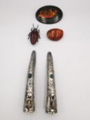 A collection of jewellery to include two Chinese white metal nail guards with repousse floral design