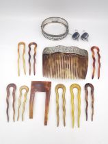 A collection of bone and faux tortoiseshell hair combs, one with a silver engraved ivy leaf top