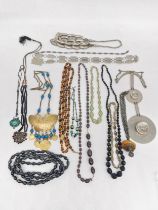 A collection of costume jewellery, including a brass butterfly necklace, a venetian foil necklace, a