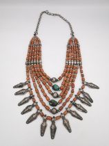 A 19th century Indian coral and turquoise bead multi strand collar necklace with white metal charms,