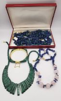 A collection of malachite and lapis jewellery, including a suite of three malachite and lapis pebble