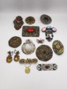A collection of costume jewellery, including seven Czech brass filigree and paste set brooches, a