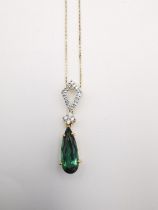 An 18 carat diamond and Santa Rosa tourmaline drop pendant on 14 carat yellow gold trace chain.