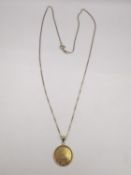 An 18ct yellow gold Ayatul Kursi (throne verse) circular pendant on a 18ct yellow gold box chain.