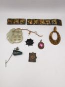 A collection of jewellery, including a miniature book charm with Napoleon on the front, a carved