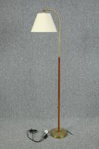 Floor lamp vintage teak with a brass base. In need or rewiring. H.158 cm.
