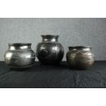 Three earthenware pots with intricate carved decorations. Early twentieth century but maybe older.