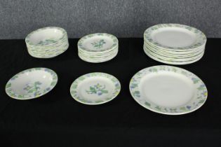 A ten person Poole pottery floral and foliate design studio pottery dinner set. Makers mark to base.