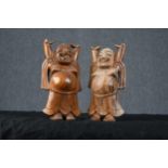 Two carved hardwood dancing Buddhas. Each measuring H.20 W.13 D.6 cm.