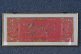 A framed embroidered dragon. Twentieth century. H.40 W.92 cm.
