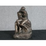 After Auguste Rodin. The Kiss. Bronzed moulded figure group. H.27 W.15 D.15 cm.