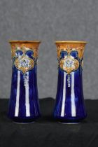 A pair of Royal Doulton vases. Floral decoration with a deep blue glaze. W.24 W.11 cm.