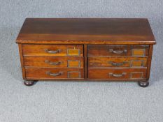 Filing chest, C.1900 stained pine on bun feet. H.40 W.95 D.38cm.