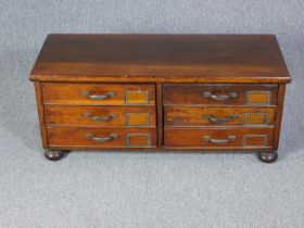 Filing chest, C.1900 stained pine on bun feet. H.40 W.95 D.38cm.