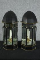 A pair of brass and painted wall mounted storm lanterns. H.60 W.28cm.