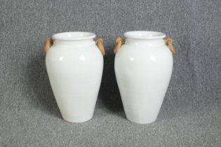 Pair of glazed terracotta urns. Each measuring H.45.5 cm.