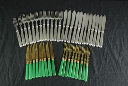 A set of eighteen desert knives & forks with green Bakelite handles and a set of twenty-four