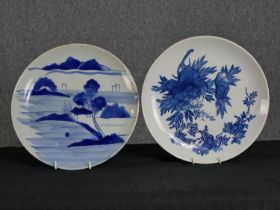 Two large blue and white porcelain plates. Twentieth century. D. 30 cm.