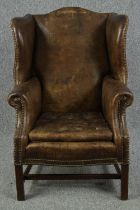 Wingback armchair, George III style mahogany framed in leather upholstery with fitted buttoned