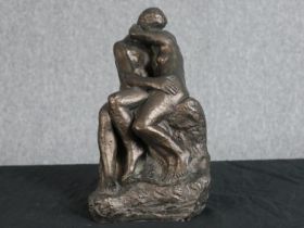 After Auguste Rodin. The Kiss. Bronzed moulded figure group. H.27 W.15 D.15 cm.