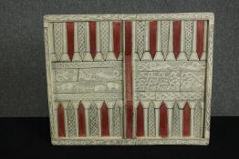 A vintage backgammon board in resin on a grp base, moulded to resemble bone and inlay.