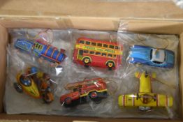 A assortment of tin and die-cast vehicles including a bus, train, fire engine and aeroplane.