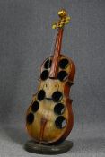 Wine rack. carved and painted hardwood in the form of a cello. H.125 W.45 D.35 cm.