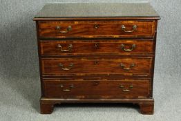 Chest of drawers, Georgian mahogany and crossbanded with brushing slide revealing a well fitted