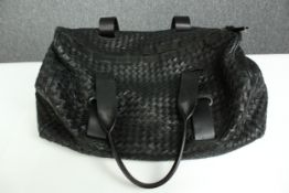 A large Bottega Veneta Intrecciato black leather weekend bag. With a suede lining and calf leather