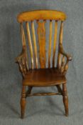 A 19th century fruitwood and elm seated Windsor armchair.