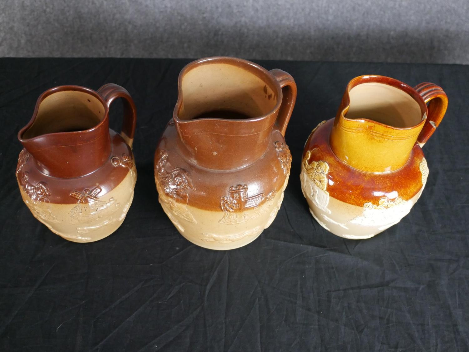 Three Doulton jugs decorated with embossed vignettes. Circa 1930. Each measure H.20 W. 19cm. - Image 2 of 6