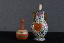 A lamp and vase both in a floral decoration. Twentieth century. The lamp measures H.45 W.21 D.14 cm.